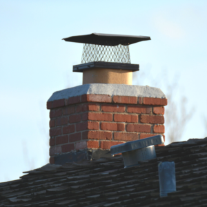 masonry chimney with a crown and metal chimney cap