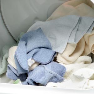 a pile of dry clothes in a dryer